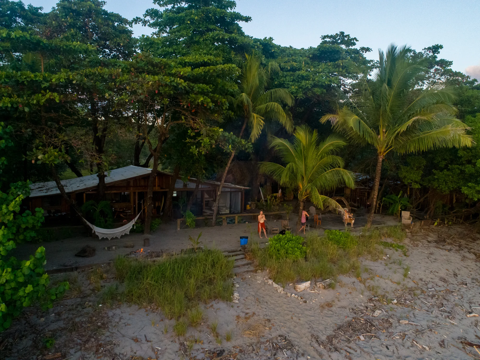 Aerial view of House of Waves: the beach house, a hammock and the gathering area by the sand