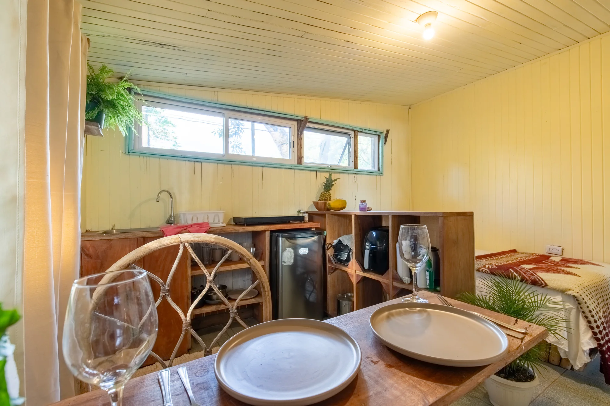 Cozy Casita dining table with kitchenette and single bed