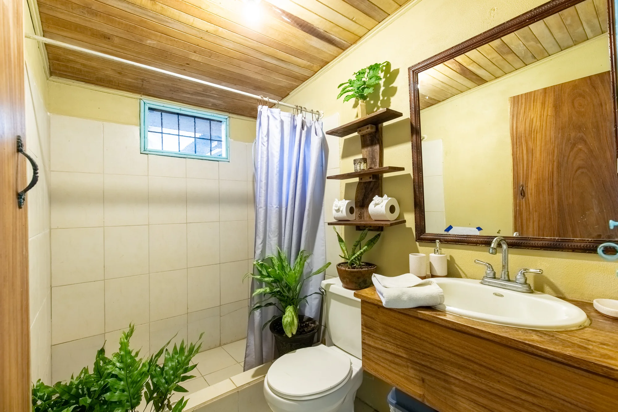 Cozy Casita bathroom with wooden counter and shower