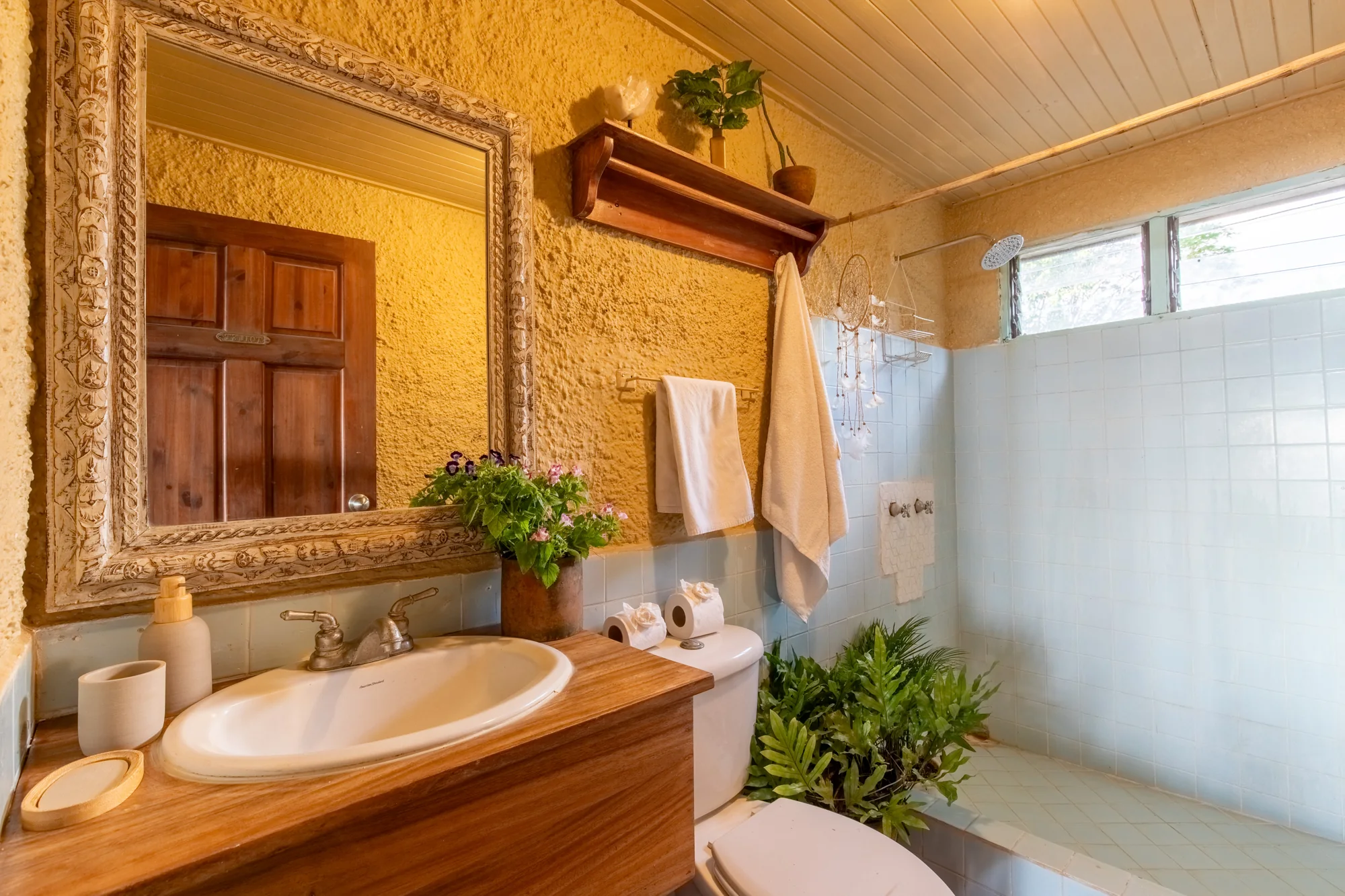 Bathroom with wooden vanity and walk-in shower